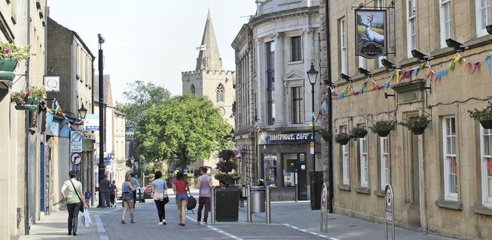 Shoppers on Mansfield town centre high street, with the church spire behind